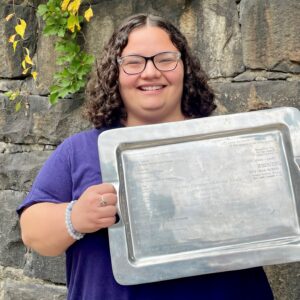 Photo of Olivia Morris holding silver tray